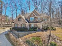 Charming two-story brick home featuring manicured landscaping and a welcoming front porch at 4375 Maverick Nw Ln, Kennesaw, GA 30152