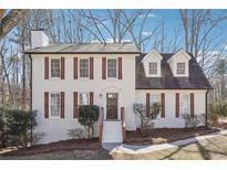 Charming two-story brick home with symmetrical design, dormer windows, and updated shutters at 3182 Glynn Mill Dr, Snellville, GA 30039