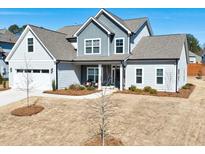 Charming two-story home featuring a covered porch and attached two-car garage, set on a well-maintained lawn at 17 Baral Rdg, Sharpsburg, GA 30277