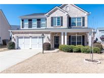 Charming two-story brick home with a well-manicured lawn and a two-car garage at 3285 Warbler Way, Cumming, GA 30041