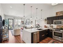 Bright, open living area featuring a modern kitchen with stainless appliances and stylish decor at 1418 Dresden Ne Dr # 355, Atlanta, GA 30319