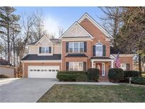 Charming two-story brick home with a well-manicured lawn and a spacious two car garage at 3510 Estates Landing Nw Dr, Kennesaw, GA 30144