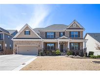 Charming two-story brick home with well-manicured lawn and attached two-car garage at 2435 Portsmouth Ct, Marietta, GA 30064