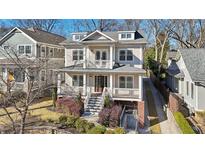 Attractive two-story home with a porch, second story balcony, well-manicured landscaping, and mature trees at 970 Drewry Ne St, Atlanta, GA 30306