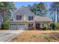 Charming two-story home featuring a two-car garage and mature trees in a serene neighborhood at 1267 Huntington Place Cir, Lithonia, GA 30058