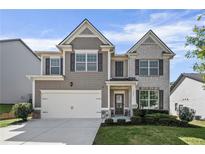 Charming two-story home with a well-manicured lawn, two-car garage, and traditional architectural details at 3845 Alden Place, Cumming, GA 30028