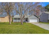 Charming single Gathering home with a well-maintained lawn and a cozy front porch at 3540 Traddsprings Way, Snellville, GA 30039