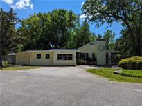 Charming yellow brick building with well-maintained asphalt parking lot and mature tree landscaping at 3941 Covered Bridge Sw Rd, Smyrna, GA 30082