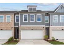 Beautiful townhouse with a brick and gray facade and a two-car garage at 1068 Rose Dr, Marietta, GA 30060