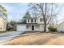 Charming two-story home featuring a cozy front porch and attached garage at 5438 Zachary Dr, Stone Mountain, GA 30083