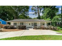 Charming home with a welcoming front porch, manicured landscaping, and a long driveway at 1551 Avon Ave, Atlanta, GA 30311