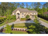 Stunning two-story brick home with meticulously landscaped front yard and circular driveway at 4434 Oglethorpe Nw Loop, Acworth, GA 30101