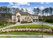 Stately brick home featuring a beautifully landscaped front yard and a curved driveway leading to a two-car garage at 4434 Oglethorpe Nw Loop, Acworth, GA 30101