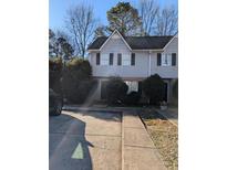 Two-story townhome featuring a gray exterior, black shutters, and a well-maintained front yard with some greenery at 4351 Logan Way, Acworth, GA 30101