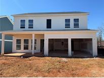 New two-story home with an attached two-car garage and a covered patio area, set in a residential neighborhood at , Conyers, GA 30094