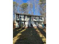 Charming two-story home with a well-maintained front yard and an attached garage at 1677 Grey Fox Ct, Lawrenceville, GA 30044