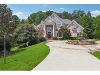 Elegant brick home features a circular driveway, fountain and mature landscaping at 2225 Johnson Ferry Rd., Marietta, GA 30062