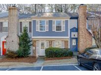 Charming two-story townhome featuring a cozy front yard with lovely landscaping and assigned parking at 6606 Wellington Sq, Norcross, GA 30093