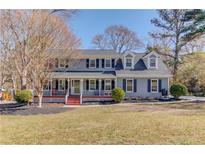 Charming two-story home featuring a welcoming front porch and well-manicured lawn at 2388 Cannon Hill Rd, Lilburn, GA 30047