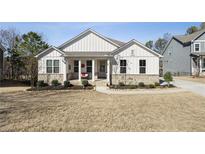 Charming single-Gathering home showcasing board and batten siding and a welcoming front porch at 23 Knollwood Nw Way, Cartersville, GA 30121