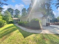 Charming single-story home featuring a well-manicured lawn, a lovely walkway, and a welcoming covered entryway at 1950 S Inlet, Marietta, GA 30066