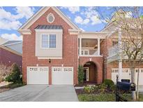 Charming brick home featuring a two-car garage and inviting covered porch at 1245 Village Terrace Ct, Dunwoody, GA 30338