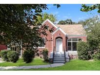 Charming brick home with landscaped front yard and inviting entryway under a clear blue sky at 1709 Rogers Sw Ave, Atlanta, GA 30310