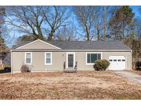 Charming single-story home featuring a cozy front porch and an attached one-car garage at 1377 Ling Dr, Austell, GA 30168
