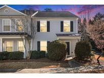 Charming two-story townhome with gray siding and black shutters, complemented by manicured landscaping and a well-maintained lawn at 3525 Parc Sw Cir, Atlanta, GA 30311