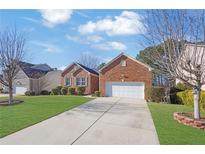 Charming one-story brick home with a two-car garage and well-maintained lawn at 720 Nightwind Way, Stockbridge, GA 30281