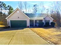 Charming single-story home with a well-maintained front yard and a two-car garage at 1150 Bradford Park Dr, Auburn, GA 30011