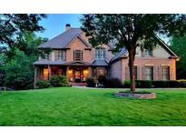 Beautiful brick home with an open lawn, covered porch and stone accents at 330 Tupelo Trl, Canton, GA 30114