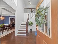 Inviting foyer with hardwood floors, staircase, and view into the dining room at 1227 Clear Stream Rdg, Auburn, GA 30011