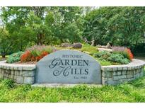 Historic Garden Hills neighborhood sign surrounded by flowers, greenery and stone, established in 1925 at 91 Rumson Ne Rd # C34, Atlanta, GA 30305