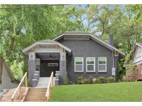 Stylish two-story brick home with a cozy front porch and well-maintained lawn, exuding curb appeal at 994 Byron Sw Dr, Atlanta, GA 30310