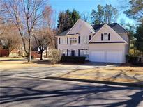 Charming two-story home featuring a manicured front yard and a two-car garage at 505 Tilbury Dr, Suwanee, GA 30024