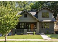 Charming two-story home with a welcoming front porch, lush lawn and professional landscaping at 1563 Westwood Sw Ave, Atlanta, GA 30310