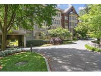 Beautiful brick and stone building with manicured landscaping and circular driveway creates an inviting, luxurious atmosphere at 1717 N Decatur Ne Rd # 322, Atlanta, GA 30307