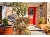 Inviting front entrance with bright red door, brick facade, and manicured landscaping at 1156 Hampton Ne Way, Atlanta, GA 30324