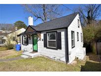 Charming cottage-style home featuring a bright green front door and classic black shutters at 232 Mathewson Sw Pl, Atlanta, GA 30314