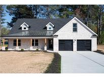 Charming one-story brick home with dormer windows and a two-car garage at 1883 Bennett Rdg, Snellville, GA 30078