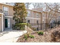 Inviting condo exterior featuring a fenced yard and neutral siding, perfect for low-maintenance living at 1307 Wynnes Ridge Se Cir, Marietta, GA 30067