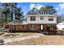 Charming two-story home with a brick facade and a welcoming front entrance at 67 Blue Springs Sw Ct, Lilburn, GA 30047