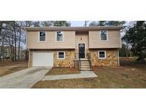 Charming two-story home with stone accents, garage, and tidy front yard at 1325 Classic Ne Dr, Conyers, GA 30013