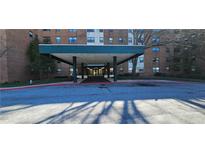 Exterior shot of covered building entrance and drive with adjacent landscaping features at 2965 Pharr Court South Nw # 316, Atlanta, GA 30305