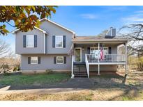 Charming split-level home with gray siding, front porch, and well-maintained landscaping at 10 Misty Hollow Ct, Euharlee, GA 30145