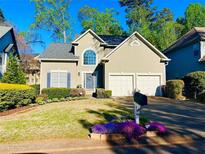 Charming two-story home with a well-manicured lawn and beautiful landscaping at 2019 Chelton Se Way, Smyrna, GA 30080