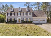 Charming two-story traditional home with gray siding, dormer windows, and attached two car garage at 2077 Moccasin Sw Way, Marietta, GA 30064