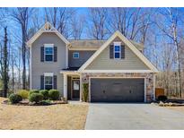 Charming two-story home with a stone-accented garage and well-manicured landscaping at 3480 Buffington Ln, Cumming, GA 30040