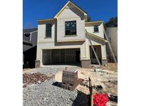 Charming two-story home features a neutral exterior, two-car garage, and unfinished landscaping at 3047 Abelia Dr, Buford, GA 30519